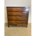 A Victorian mahogany chest of drawers with inlaid ivory key detail and brass handles. Some losses to