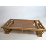 A wooden adjustable over bed table and book restW:74cm x H:16cm x D:42