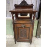 A large Edwardian mahogany purdonium with lead lined coal storage below mirrored shelf and carved