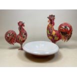 Two hand painted metal cockerels also with a large glazed pottery bow. Large cockerel H:46cm