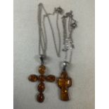 Two amber and silver crosses.