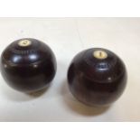 A pair of vintage bowling balls made by Thomas Taylor of Glasgow, numbered 1 and 2
