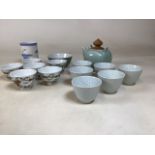 A collection of oriental ceramics including a teapot with wooden lid and six cups, six rice bowls