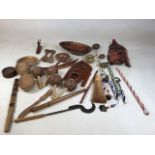 A collection of African tribal items including ceremonial wooden and beaded sticks, wooden ornaments
