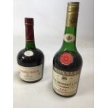 Two bottles of Cognac: a bottle of Courvoisier and one other