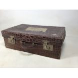 A vintage crocodile skin suitcase with shipping labels from Ellermans City Line W:56cm x D:35cm