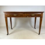 An early 20th century mahogany desk with brass handles, tapered legs with ceramics and brass