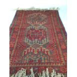 A handmade wool vintage rug W:80cm x H:132cm excluding fringe