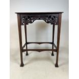 A Small occassional table with flared legs and fret work front and back.