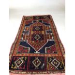A vintage woollen rug - some wear W:57cm x H:107cm