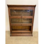 An gun oak sectional bookcase. Glass missing to base. W:87cm x D:33cm x H:113cm