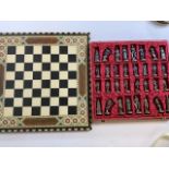A gilt metal chess set also with a chess and draughts board.