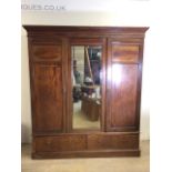 An Edwardian inlaid triple wardrobe with central mirror and two drawers to base. For restoration.