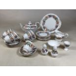 A Paragon Fine Bone china tea set in Country Lane design. Includes tea pot, jug and sugar bowl, cake