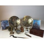 A collection of metalware to include candlesticks, engraved chargers, pewter bowl and other items