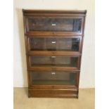 An oak Globe Wernicke bookcase with four sections, top and base. Each section with The Globe