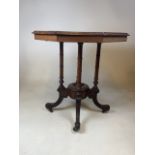 A Victorian octagonal inlaid walnut veneered occasional table with carved and turned legs to base on