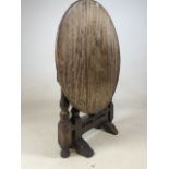 A small country oak tilt top circular table. W:58cm x D:58cm x H:51cm