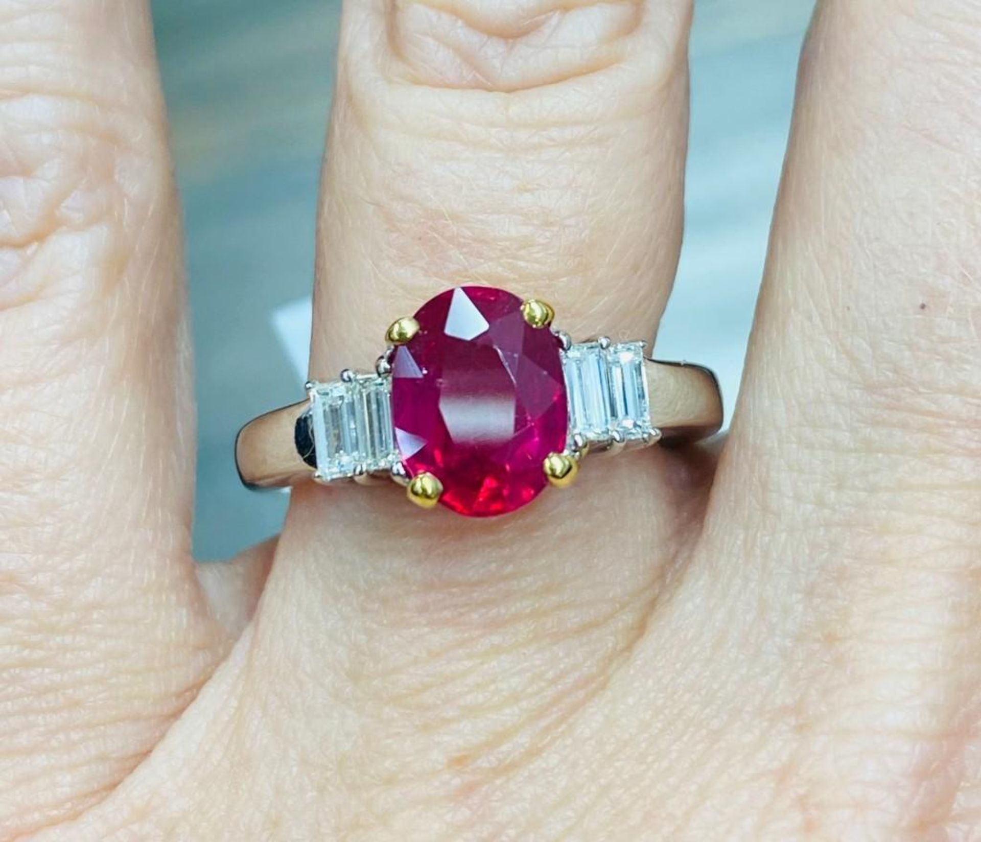 CLARITY ENHANCED RUBY AND BAGUETTE DIAMOND RING. APPROXIMATELY 2.10CT RUBY. APPROXIMATELY .40CT NICE