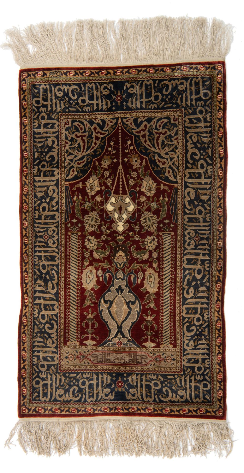 An Oriental silk on silk Hereke rug, decorated with a flower vase, the details finely brocaded with