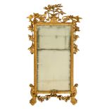 A gilt and carved wooden Louis XVI period pier-glass, abundantly decorated with flower branches, gar