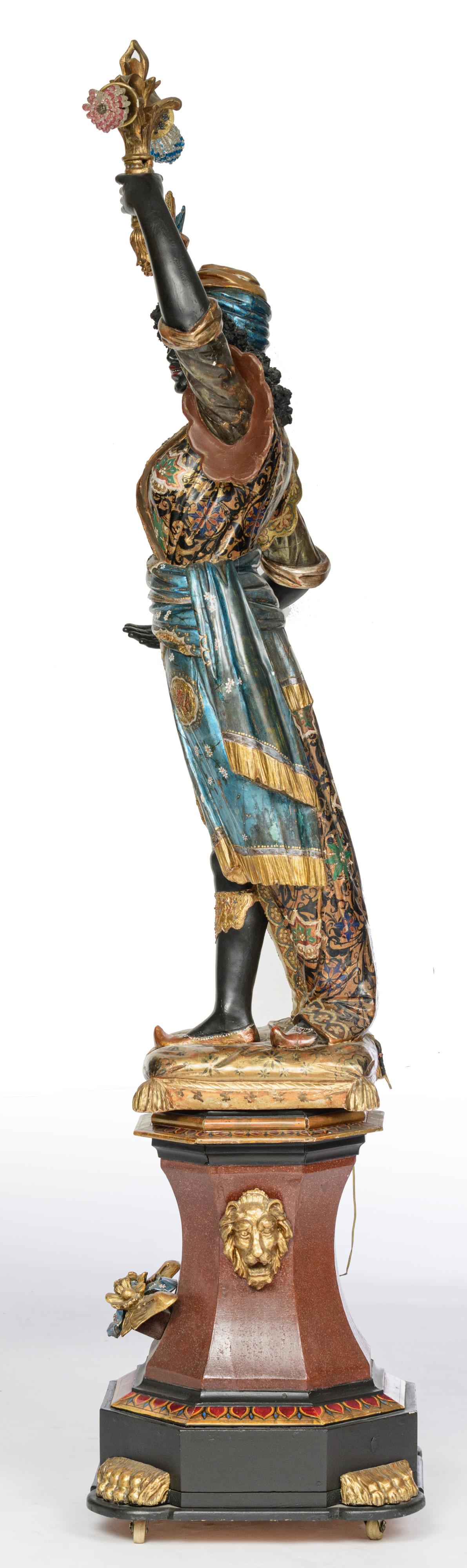 A Venetian polychrome painted and gilt wooden blackamoor torchŠre figure, dressed in an elaborately - Image 2 of 6