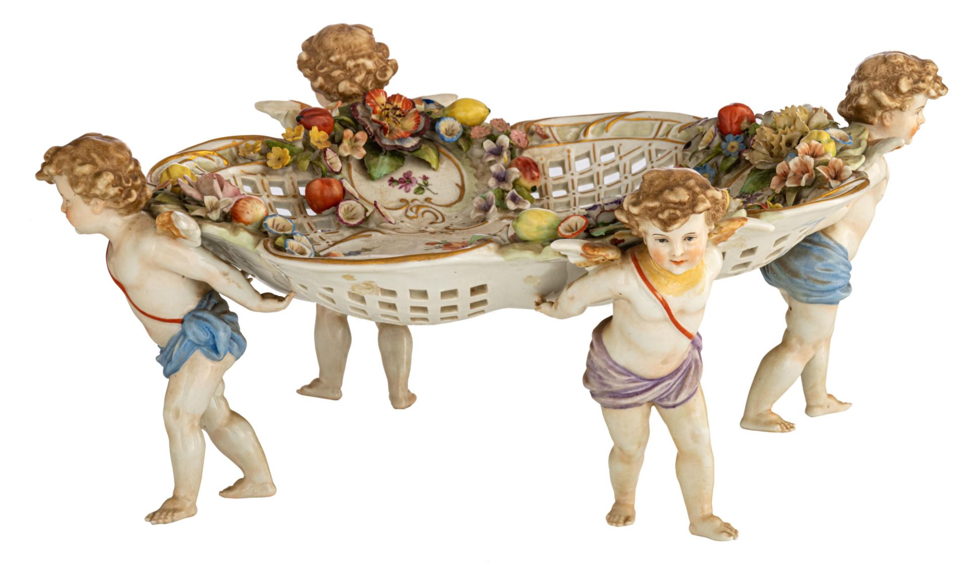 A polychrome decorated Saxony porcelain 'piŠce de milieu' with four angels carrying the openworked b
