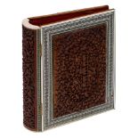 A Middle Eastern walnut book folder, with richly carved alto-relievo horror vacui panels, depicting