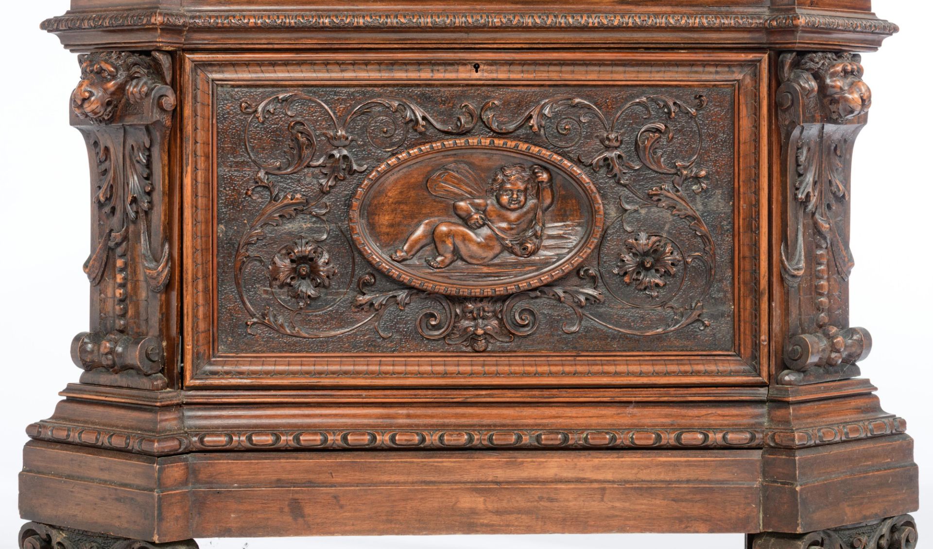 A richly sculpted walnut Renaissance style display cabinet, decorated with scrollwork, lion heads an - Image 8 of 12