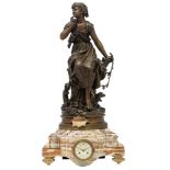 A volcanic marble mantle clock, with on top a patinated bronze figure 'Chant de l'Aloutte' by Hyppol