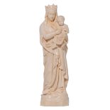 A large ivory Madonna holding the Holy Child and destroying the serpent as a symbol of evil, signed