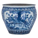 A Chinese blue and white cachepot, the panels decorated with birds and flower branches, with a Kangx