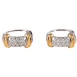 A pair of 18ct white and yellow gold stud earrings set with 14 brilliant-cut diamonds each, the tota