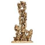 A Japanese patinated ivory okimono, depicting a jolly Oni party, signed, late Edo ? early Meiji peri