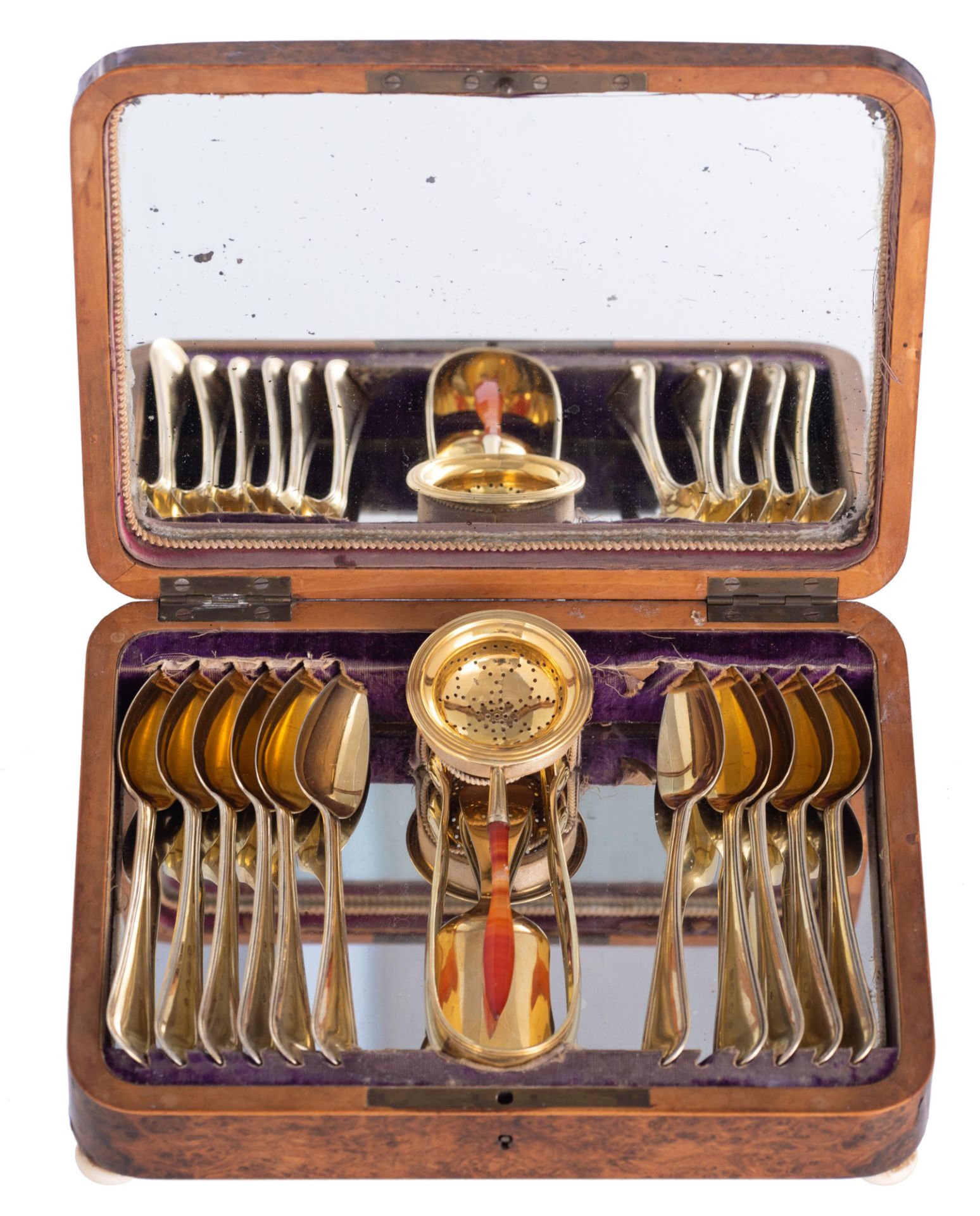 A silver vermeil tea set with 11 spoons, a tea strainer with a coloured glass stem, a spoon and a to