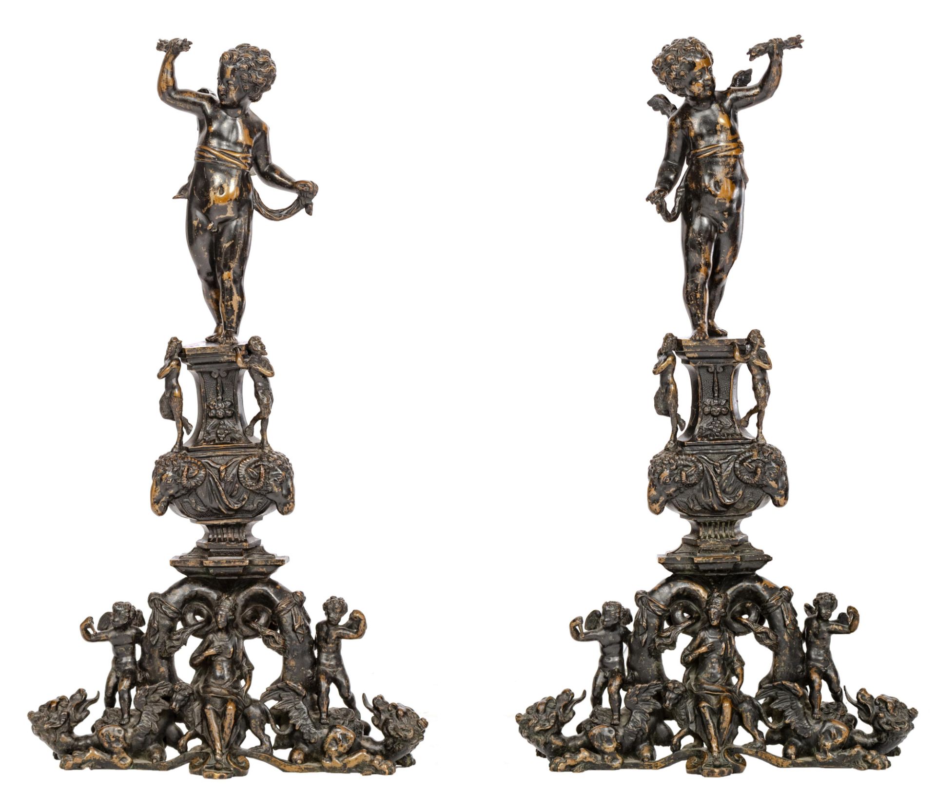 An impressive pair of Renaissance style patinated bronze andirons, topped with winged putti above an