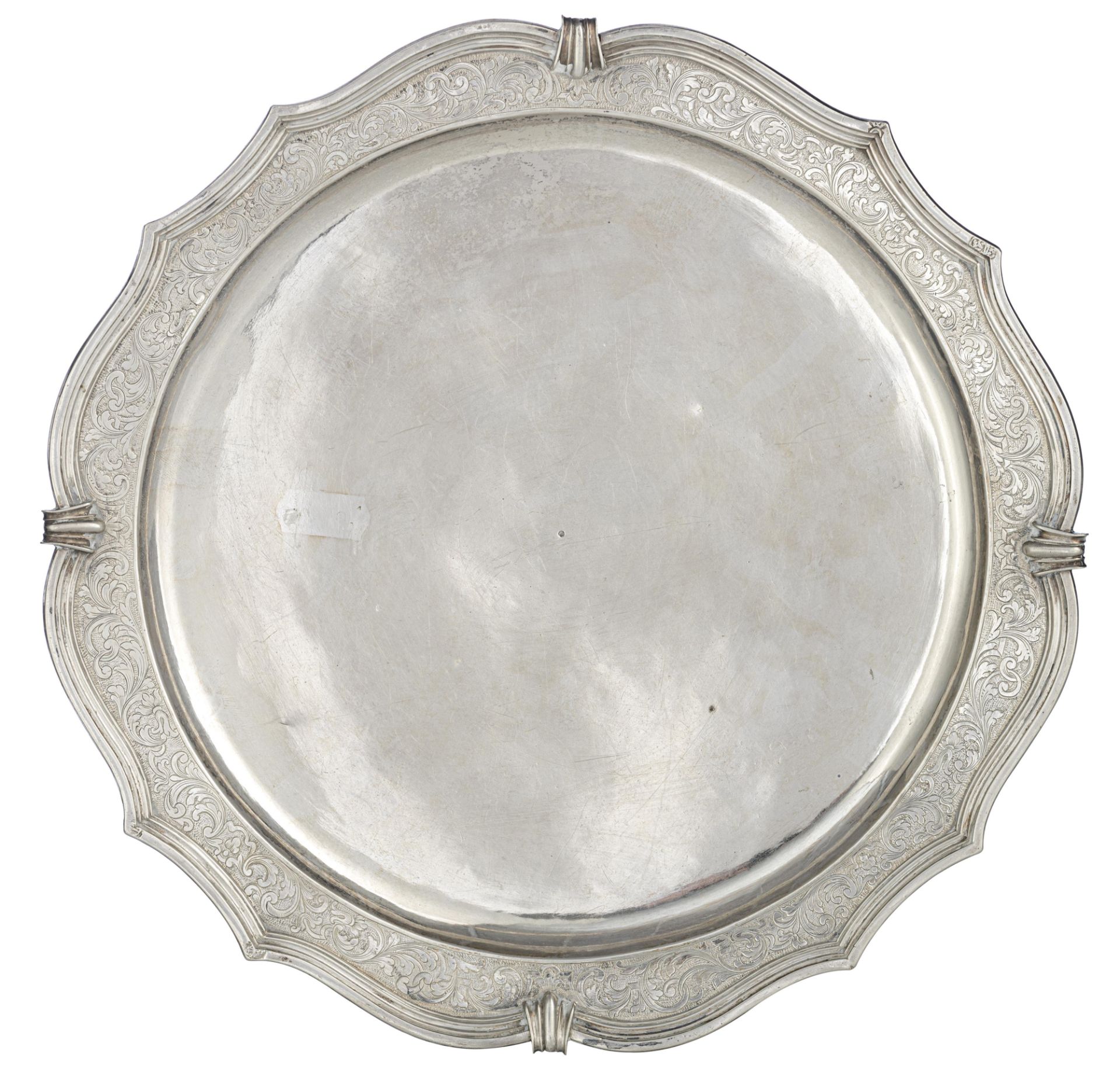 An 18thC circular French R‚gence silver salver, the gadrooned rim engraved with arabesque decoration