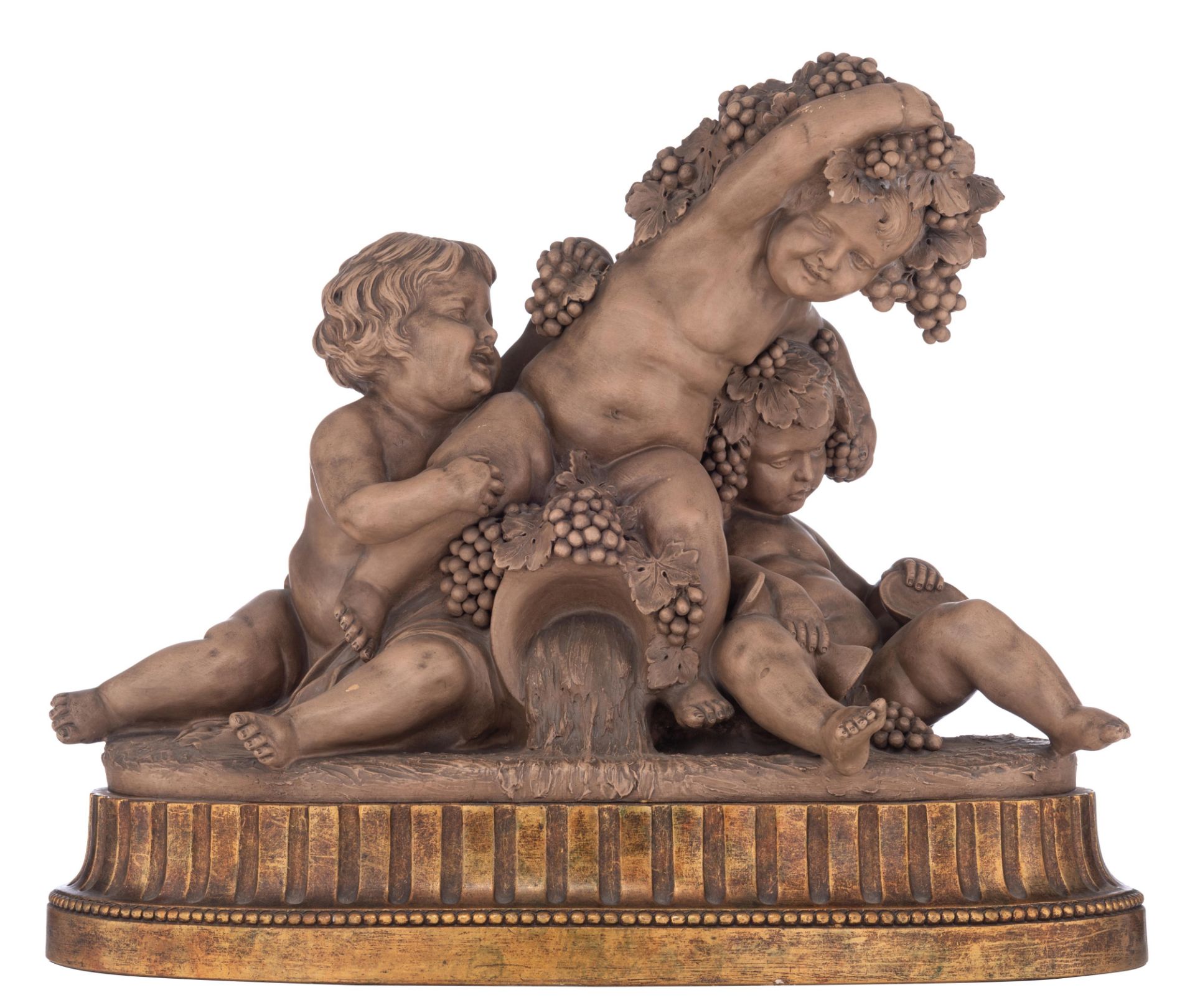 Calendi, a patinated terracotta group depicting putti playing with grapes around a source, on a gilt