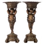 A pair of bronze urns, decorated with putti and garlands, H 40 cm