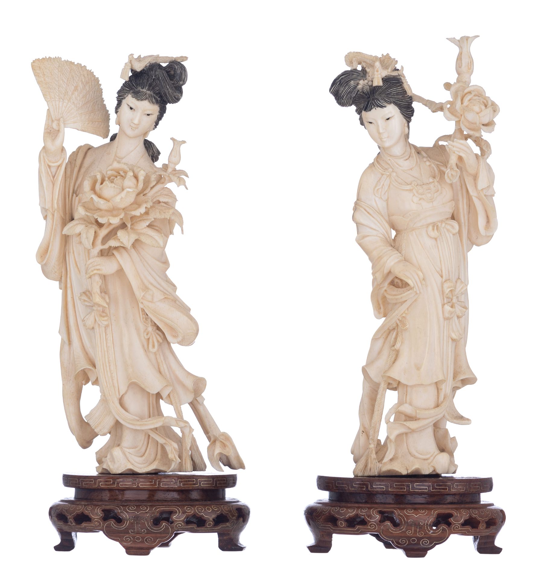 Two ivory Chinese beauties on wooden bases, first half 20thC, H 24 - 25 cm,