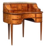 A mahogany and walnut veneered English 'Carlton house' desk, decorated with brass mounts and marquet