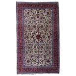 A large Oriental woollen rug, decorated with floral motifs, 505 x 297 cm,
