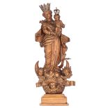 A walnut sculpture of the Madonna holding the Holy Child and standing on the crescent moon destroyin