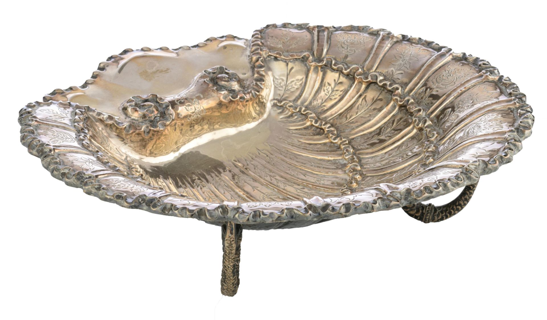 A silver shell-shaped compote on three dolphin-shaped feet, with floral decoration and a ribbon-shap