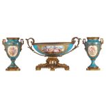 A three-piece soft-paste porcelain garniture in the SŠvres manner with gilt bronze mounts, with a bl