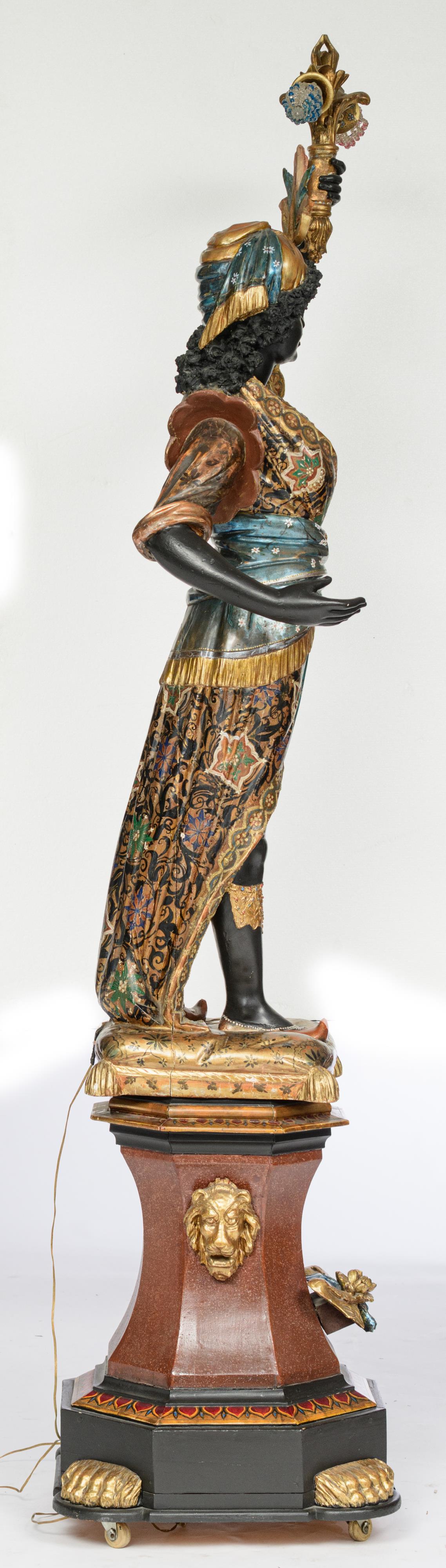 A Venetian polychrome painted and gilt wooden blackamoor torchŠre figure, dressed in an elaborately - Image 4 of 6