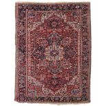 An Oriental woollen rug, decorated with geometric motifs, 240 x 325 cm