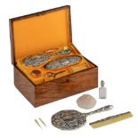 A luxurious walnut ladies vanity box, with Rococo-inspired silver, bone and glass utensils, and a gu