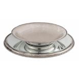 An 835/000 silver fruit tray, set on a silver-mounted mirror platter, made by the Wolfers - Brussels