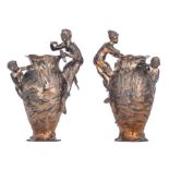 A pair of Art Nouveau silver plated vases, decorated with a child fishing in a pond, the handles sha